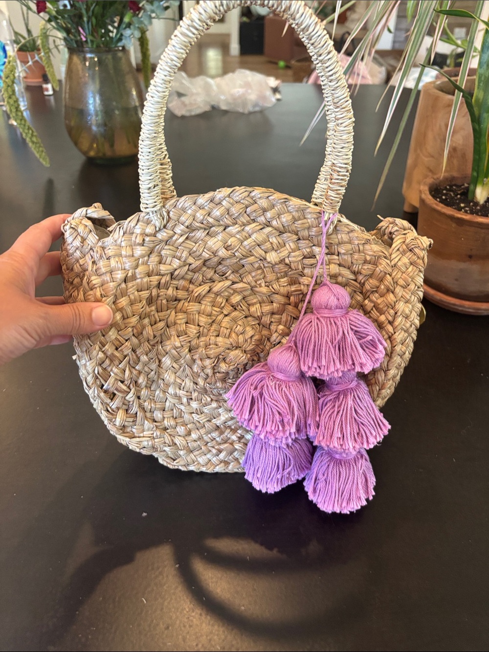 Small rattan purse with removable purple poms